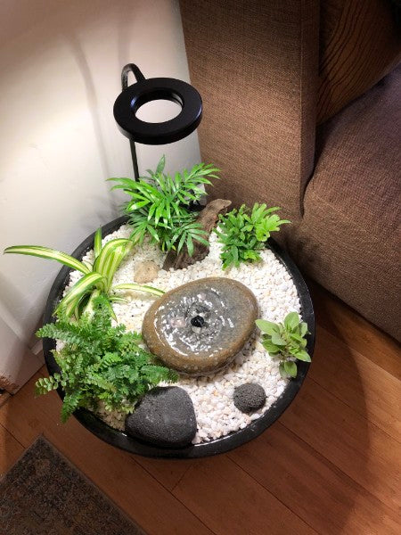 Handcrafted stone fountain in a home garden